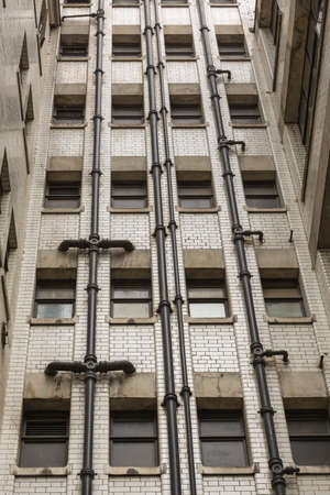 Old fashioned plumbing in London with all pipes exterior to the buildingの写真素材