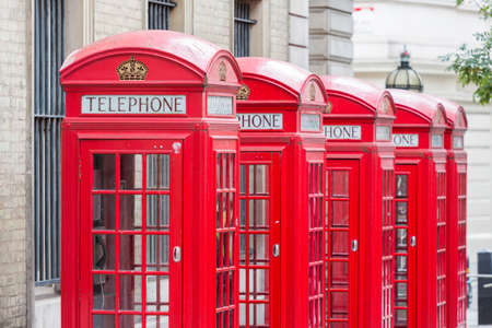 Five Red London Telephone boxes all in a row in the City