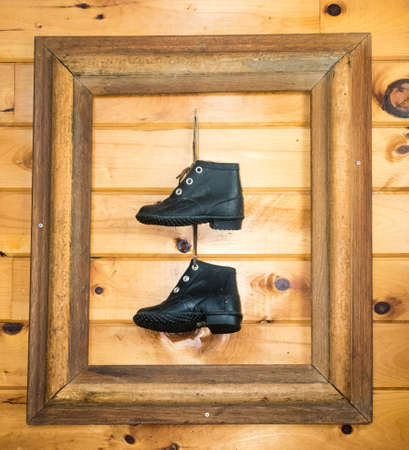 A pair of old boots framed and not made for walking