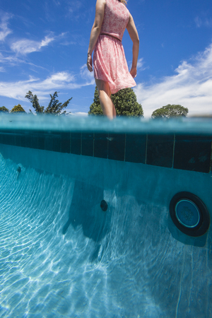 Girl Testing Swimming Pool Waters の写真素材