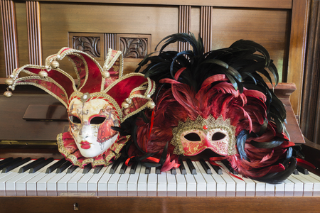 Masks for a party ball resting on piano の写真素材