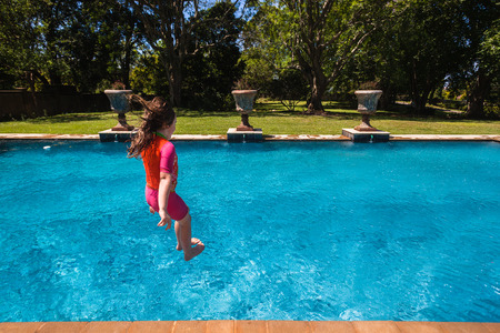 Children Playing In Swimming Pool Outdoors Summerの写真素材