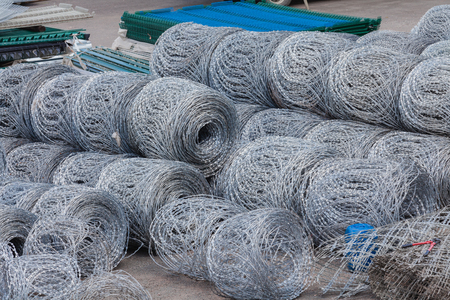 Razor wires rolls stacked yard fencing security の写真素材