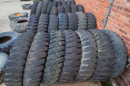 Large Tires used on industrial heavy mechanical machines stacked togetherの写真素材