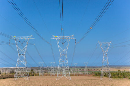 Electricity Cable power lines held up over the countryside by steel tower structures の写真素材