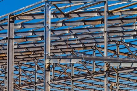 Building warehouse steel metal frame structure in morning blue skyの写真素材