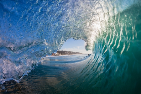 Inside hollow crashing morning waves with water detail from surfing or swimmers view