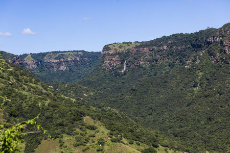 Rural terrain in valley with cliffs waterfalls in the summerの写真素材
