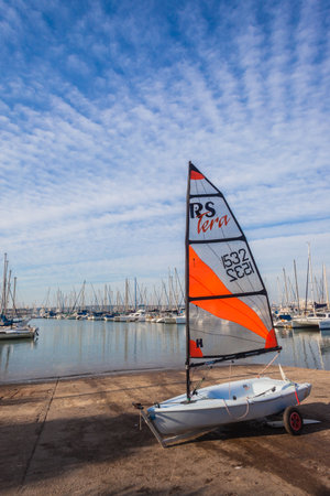 Sailing junior single sailor yachts on harbor slipway waiting for morning winds for junior sailors のeditorial素材