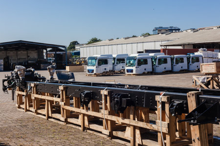 Truck vehicle assembly plant with chassis engines tops in outdoor storage yardsのeditorial素材