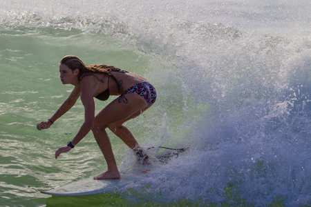 Surfer girl rides summer wave close up photo of action のeditorial素材