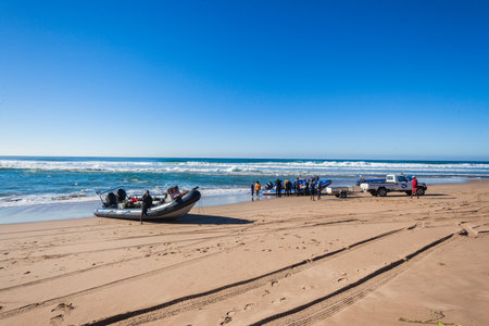 Scuba diving boats on beach offloading divers and boarding new clients to sea to underwater shoal diving のeditorial素材