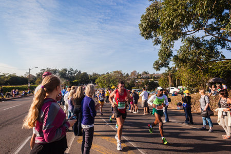 Marathon ultra distance race runners in morning sun light and local supporting crowdsのeditorial素材