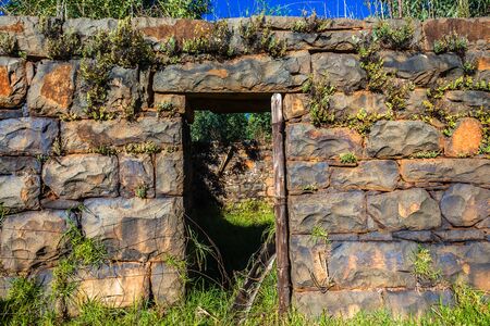 Old granite stone block walls of farm house building ruins in rural countryside mountainsの写真素材