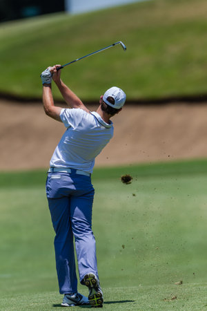 Professional Tommy Fleetwood swings and strikes his ball at the European pga Volvo Golf Champions tournament at Durban Country club South Africaのeditorial素材