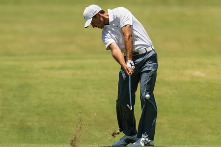 Professional Golfer Charl Schwartzel swings to strike ball at European PGA Tournament Volvo Golf Champions Tournament play action at Durban Country Club  January 2014 South Africaのeditorial素材