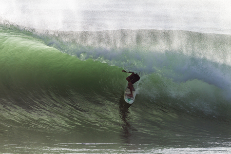 Surfing large cyclone summer waves surfer at Durban s new pier beach surf city の写真素材