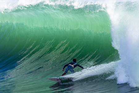 Surfing large cyclone summer waves surfer at Durban s north beach surf city の写真素材