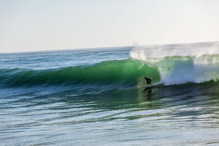 Surfing large cyclone summer waves Jordy Smith at Durban s north beach surf city の写真素材