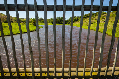 Wood pole constructed outdoor wetland entertainment deck with low child s view looking over wetland dam watersの写真素材