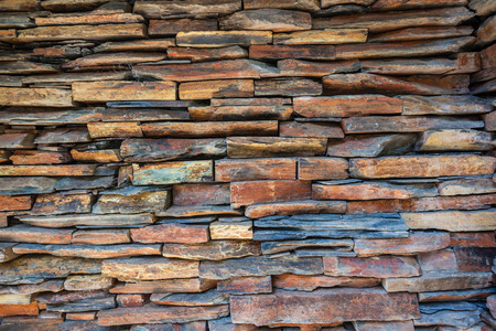 Stone colored slate wall stacked in different decor shape and sizes for artistic look effect の写真素材