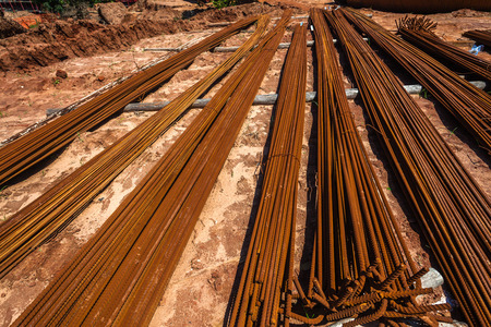 Civil Engineering Construction Steel metal rods lay stacked  for strength installation in concrete columns constructionの写真素材