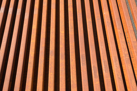 Steel Railway manufactured new track lines stacked close together ready to install and maintenance engineering repairs   Abstract angles photo of metal linesの写真素材