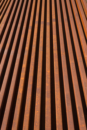 Steel Railway manufactured new track lines stacked close together ready to install and maintenance engineering repairs   Abstract angles photo of metal linesの写真素材