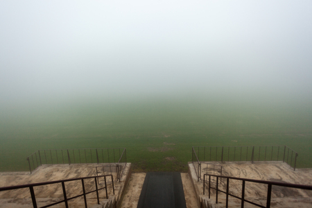 Sports field stadium player run-on section covered in thick cloud mist with short visibilityの写真素材