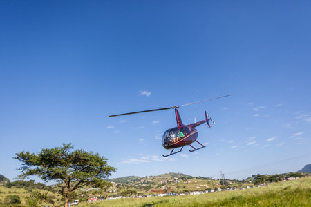 Canoe River race marathon with media helicopter low flying in valley のeditorial素材