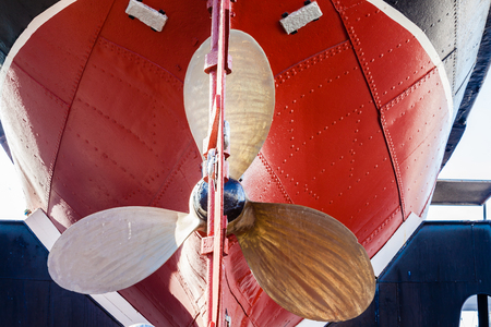 Steam Tug boat vessel with its brass propellor dry-docked on blocks retired shipping marine engineering era の写真素材