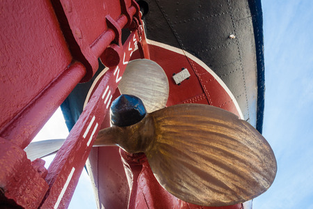Steam Tug boat vessel with its brass propellor dry-docked on blocks retired shipping marine engineering era の写真素材