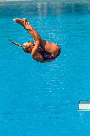 Girl in mid flight dive at national aquatic diving competitionのeditorial素材