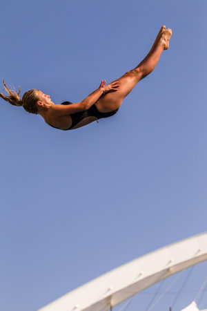 Girl in mid flight dive at national aquatic diving competitionのeditorial素材