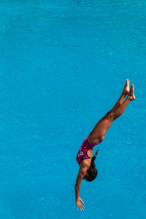 Girl in mid flight dive at national aquatic diving competitionのeditorial素材