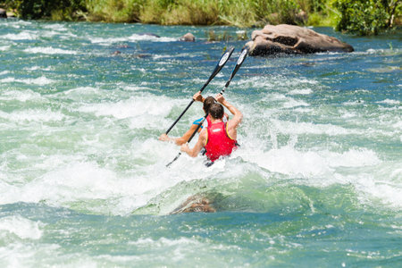 Dusi canoe race action drama at Inanda Rapids with paddlers going through rushing river watersのeditorial素材