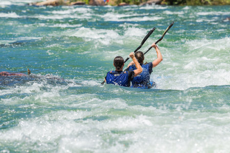 Dusi canoe race action drama at Inanda Rapids with paddlers going through rushing river watersのeditorial素材
