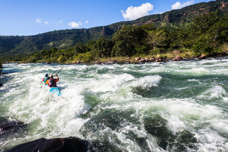 Dusi canoe race action drama at Inanda Rapids with paddlers going through rushing river watersの写真素材