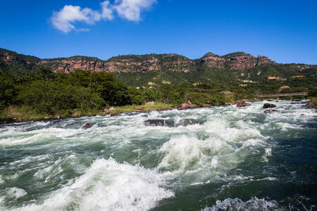 Fast flowing River waters with rock rapids dangerous sections in kayaking and canoe sportsの写真素材