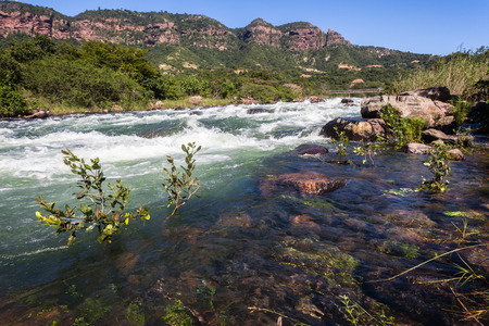 Fast flowing River waters with rock rapids dangerous sections in kayaking and canoe sportsの写真素材