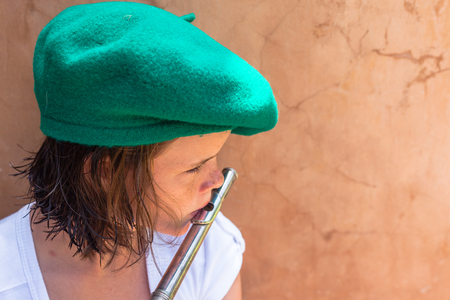 Teen girl practice her music notes flute playing at homeの写真素材