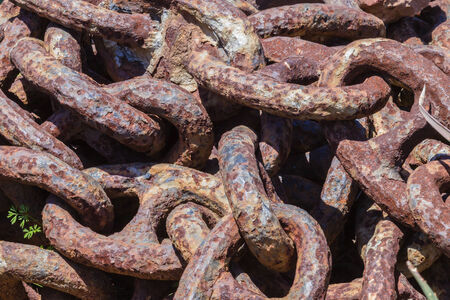 Large chain links attached to anchor for ships rustingの写真素材