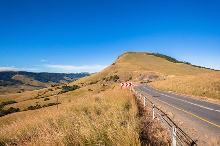 Scenic road through high mountain valley rugged terrain landscapeの写真素材