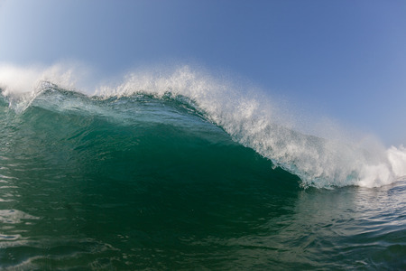 Ocean wave lip crashing towards shallows with power energy of natureの写真素材