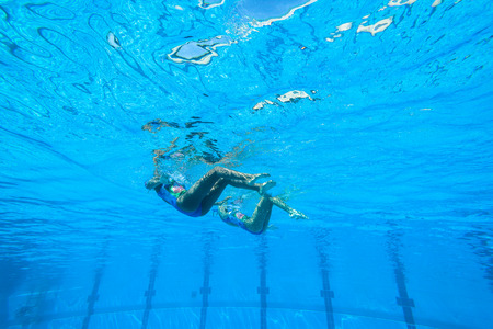 Girls Synchronized swimming in water actionの写真素材