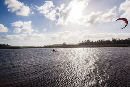 Kite surfing in lagoon surf action beach river lagoon north of Durban South Africaの写真素材