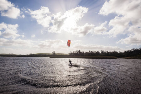 Kite surfing in lagoon surf action beach river lagoon north of Durban South Africaの写真素材
