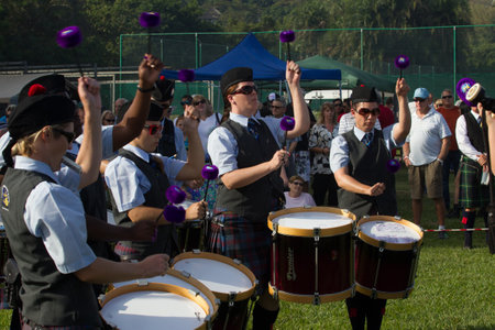 Scottish Bands men and women play musical instruments in traditional colors at the Scottish Highland Gathering のeditorial素材
