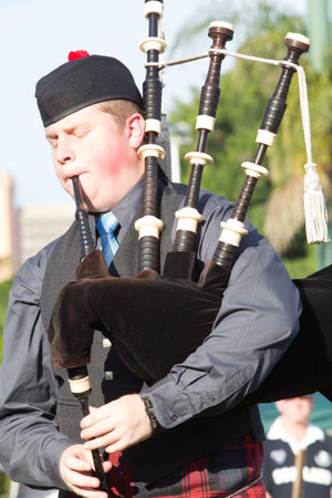 Scottish Bands men and women play musical instruments in traditional colors at the Scottish Highland Gathering のeditorial素材