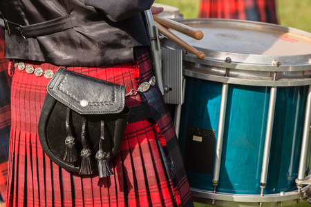 Scottish Bands men and women play musical instruments in traditional colors at the Scottish Highland Gathering の写真素材